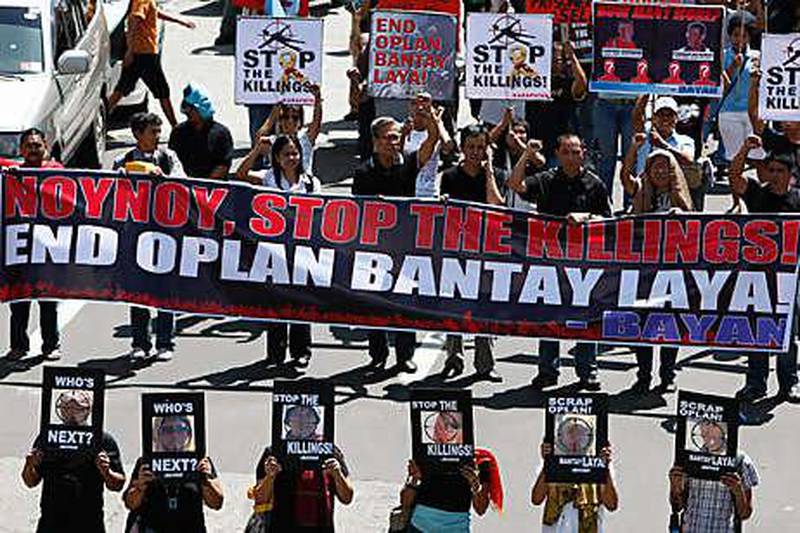 Rights activists protest in Manila against killings.