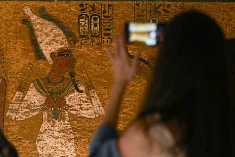 A tourist takes photos inside the tomb chamber of King Tutankhamun in the Valley of the Kings in Luxor. AP Photo