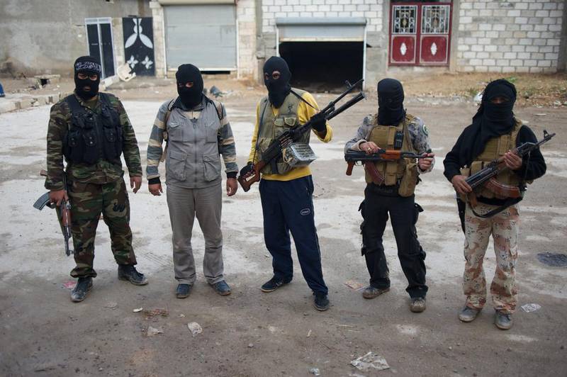 Alleged Jabhat Al Nusra members pose in eastern Syria. Al Nusra’s surge has alarmed many citizens in southern Deraa province, and the western and Arab states backing moderate fighting groups. Courtesy Balint Szlanko / November 2012