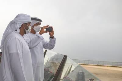 Sheikh Mohamed bin Zayed takes pictures of the view from Al Suhub Rest Area.