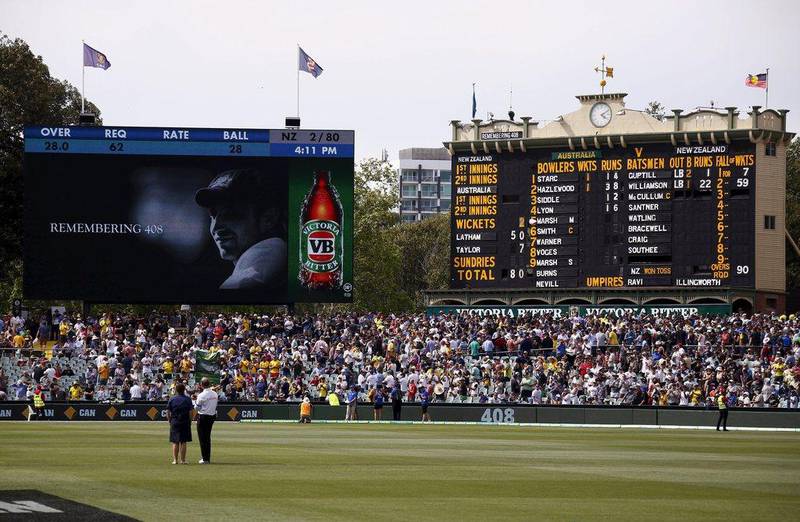 A tribute to former Australian cricketer Phillip Hughes, who was the 408th player for Australia, is displayed on a screen next to the scoreboard during the first day of the third Test between Australia and New Zealand at the Adelaide Oval. David Gray / Reuters