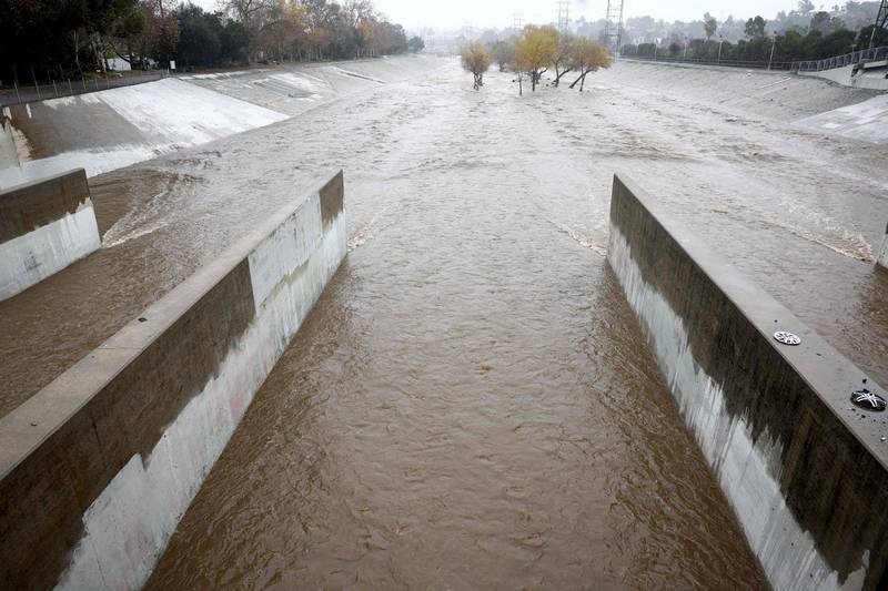 The Los Angeles River flows strongly during the storm on Monday in California. Getty / AFP