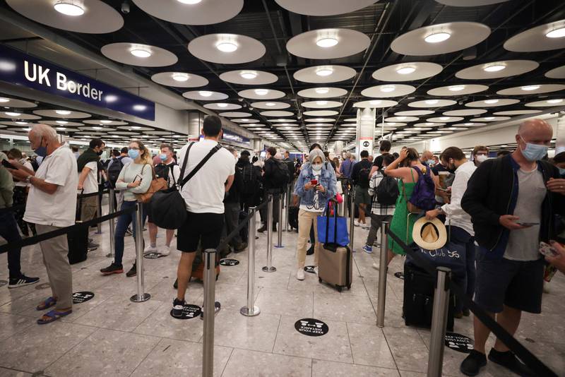 Arriving passengers queue at Terminal 5 of Heathrow Airport, in London. Hannah McKay / Reuters