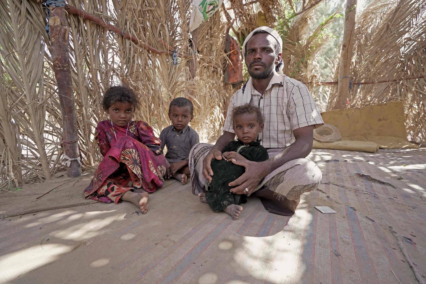 Yehya Hayba and his children, who fled fighting between Huthi rebels and the Saudi-backed government forces, at the Al Sumya camp.