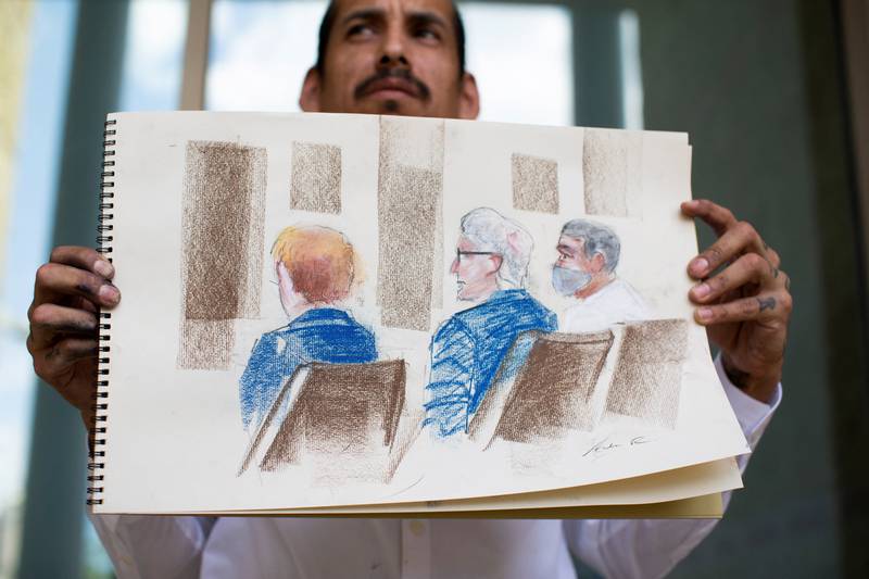 Andrei Renteria holds his courtroom sketch, where Homero Zamorano Jr, the suspected driver of a lorry packed with dozens of migrants who died in blazing heat during a Texas smuggling attempt, attends a court hearing in San Antonio. Reuters