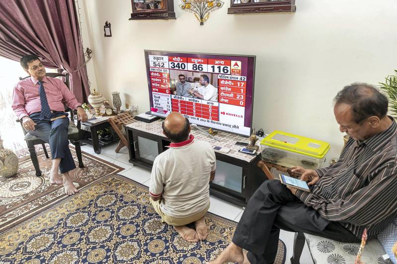 DUBAI, UNITED ARAB EMIRATES. 23 MAY 2019. Indian Election results. BJP supporters wait for the results at Ashok and Komal Ashok Bhagnari’s home in Dubai of the Indian Election results. Ramakant Dixit, center, watches the results closely. (Photo: Antonie Robertson/The National) Journalist: Ramola Talwar. Section: National.