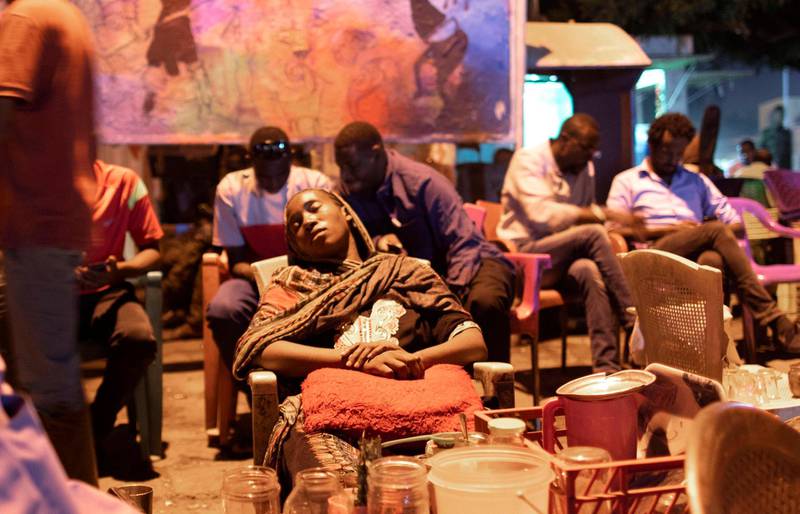 A Sudanese tea vendor falls asleep after iftar in Khartoum, Sudan.  EPA