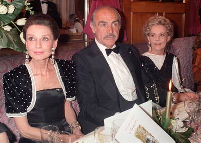 Photo datée 07 mars 1987 des comédiens Audrey Hepburn (G), Sean Connery (C) et Jeanne Moreau (D) dans le restaurant Le Fouquet's à Paris, lors de la 12e Nuit des Césars. (Photo by MICHEL GANGNE / AFP)