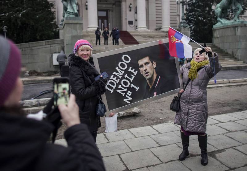 Supporters hold a banner reading "Let's go Nole (Novak)" with a picture of Serbian tennis player Novak Djokovic, during a rally in front of Serbia's National Assembly, in Belgrade. AFP