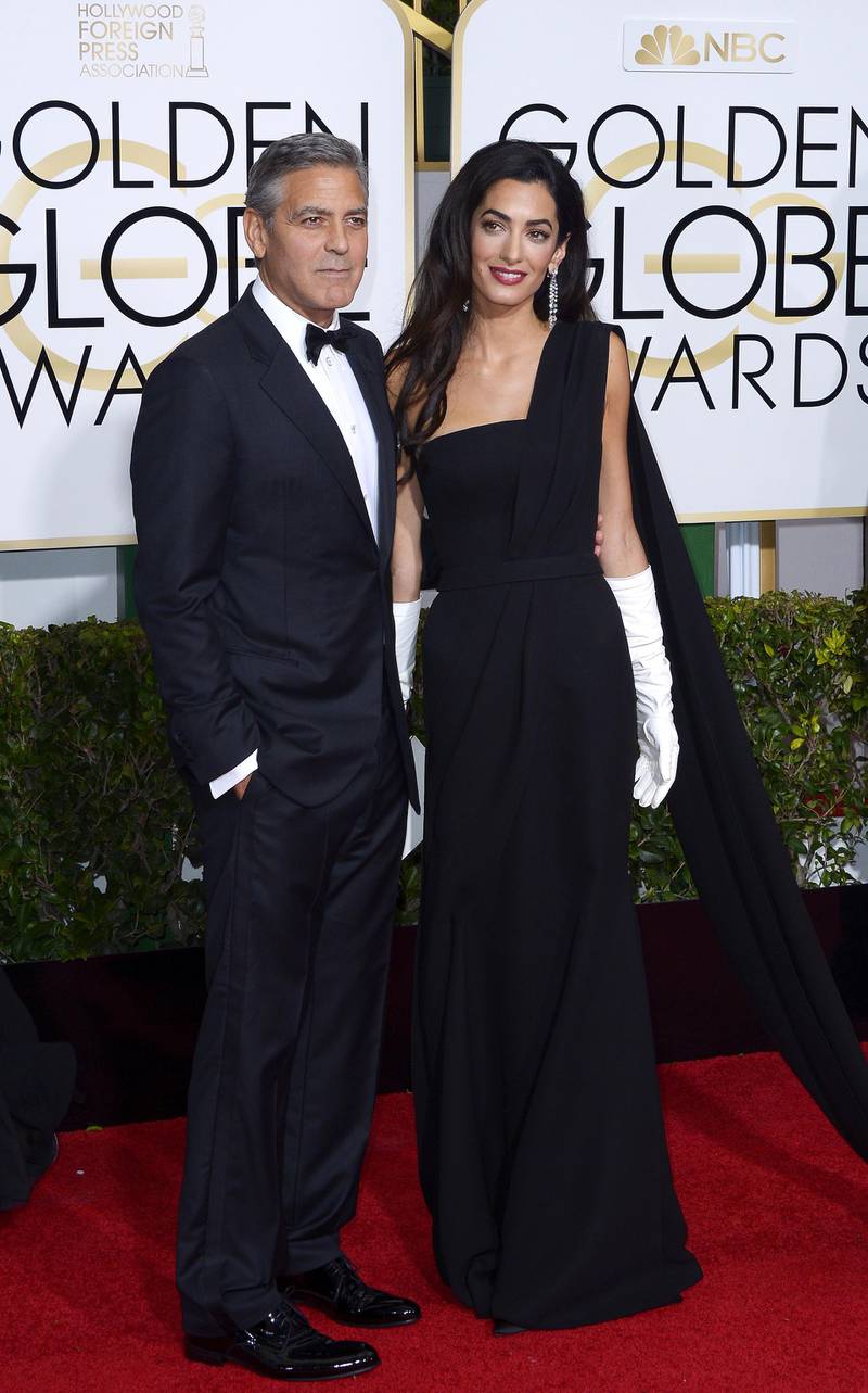epa04556452 George Clooney (L) and wife Amal Clooney (R) arrive for the 72nd Annual Golden Globe Awards at the Beverly Hilton Hotel, in Beverly Hills, California, USA, 11 January 2015.  EPA/PAUL BUCK