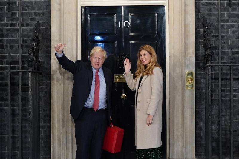 LONDON, ENGLAND - DECEMBER 13: Prime Minister Boris Johnson and his partner Carrie Symonds enter Downing Street as the Conservatives celebrate a sweeping election victory on December 13, 2019 in London, England. Prime Minister Boris Johnson called the first UK winter election for nearly a century in an attempt to gain a working majority to break the parliamentary deadlock over Brexit. As the results roll in the Conservative Party has gained the number of seats needed to win a clear majority at the expense of the Labour Party. Votes are still being counted and an overall result is expected later today. (Photo by Peter Summers/Getty Images)
