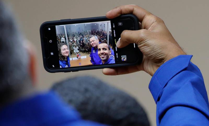 Major Hazza Al Mansouri snaps a selfie with Jessica Meir and Oleg Skripochka with dozens of media behind them at Baikonur Cosmodrome in Kazakhstan. Dmitri Lovetsky / AP