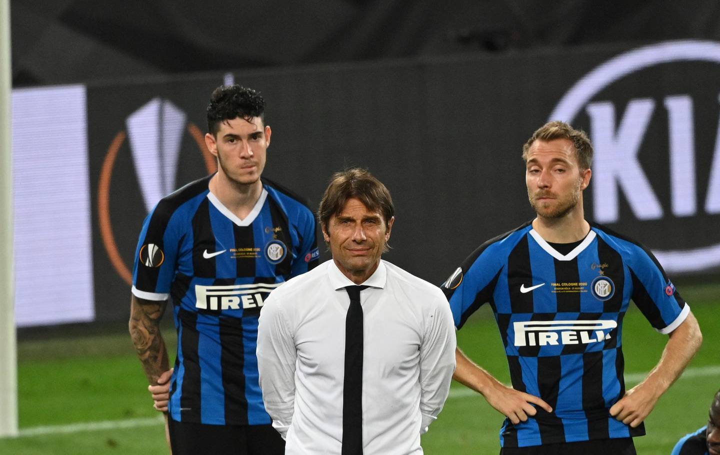 Inter Milan's head coach Antonio Conte, centre, and players react after the Europa League final soccer match between Sevilla and Inter Milan in Cologne, Germany, Friday, Aug. 21, 2020. (Ina Fassbender/Pool via AP)
