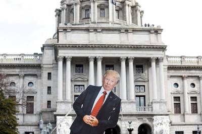 A cardboard cutout depicting US President Donald Trump is seen in front of Pennsylvania State Capitol in Harrisburg, Pennsylvania. Reuters