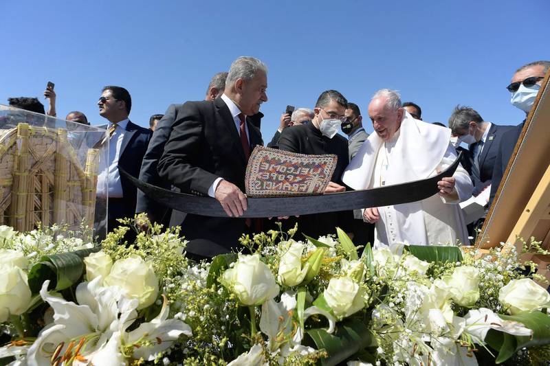 Pope Francis is seen behind flowers at an interfaith service at the House of Abraham in the ancient city of Ur. EPA
