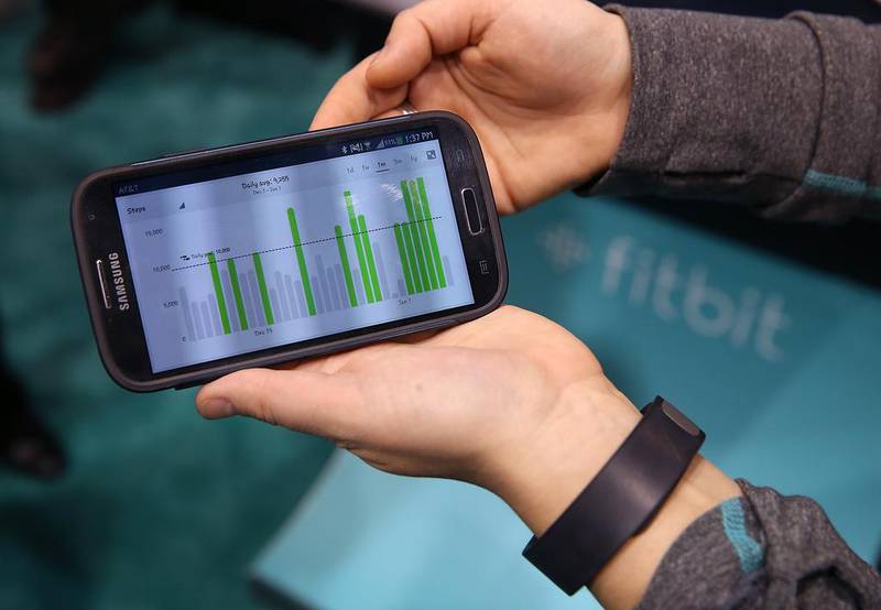 Data collected from the Fitbit Force is displayed on a smartphone at the 2014 International Consumer Electronics Show in Las Vegas, Nevada. Fitbit has issued a voluntary recall on its Force wristbands after reports began surfacing in January that the device was causing a painful skin irritation for some users. Justin Sullivan / Getty Images / AFP