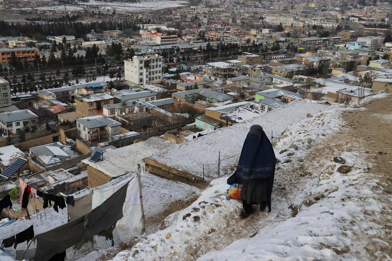 A woman looks down over Fayzabad, in Afghanistan's Badakhshan province, on January 18. AFP