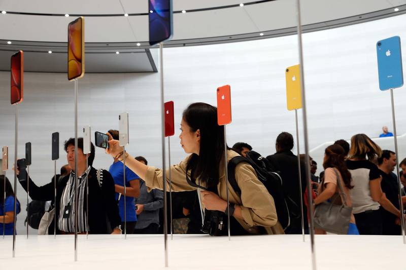 People take photos of the new Apple iPhones. Reuters