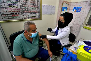A man receives the AstraZeneca vaccine at a clinic in Baghdad. Less than one per cent of the country's population has been vaccinated. AP