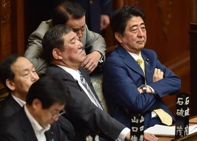 Japan's PM Shinzo Abe and members of his cabinet attend a lower house plenary session about controversial security bills at the parliament in Tokyo on July 16. AFP 