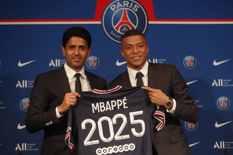 Kylian Mbappe and PSG president Nasser Al-Khelaifi during a press conference to announce the striker's new contract. AP