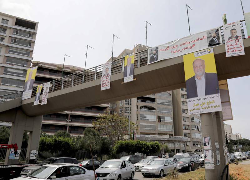 A picture taken on April 3, 2018 shows campaign posters, for the upcoming Lebanese parliamentary election, hanging in the industrial zone of Dora on the northern outskirts of Beirut.
As its first parliamentary vote in nearly a decade nears, Lebanon has been swept into campaign fever: posters on every corner, televised debates, and neighbours bickering over new electoral procedures. / AFP PHOTO / AFP- / Anwar AMRO