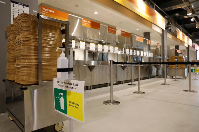 A hand sanitizer and a sign for Covid-19 countermeasures are placed at the main dining hall.
