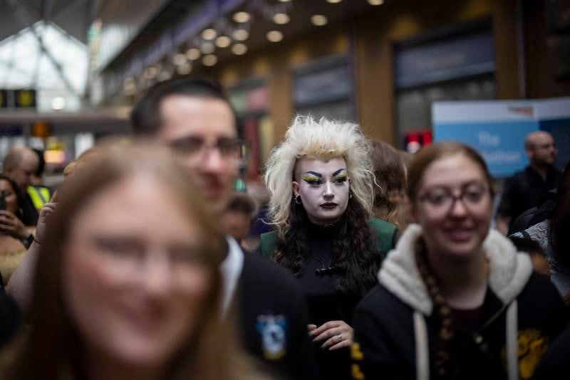 Harry Potter fans in costume gather to celebrate the 25th anniversary of the first book's release, at King's Cross Station in London. EPA