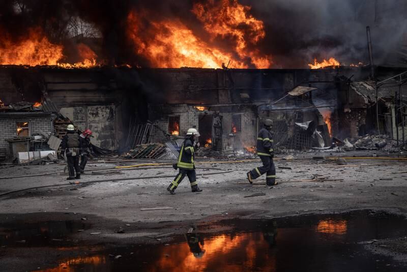 Firefighters work to extinguish a fire at a warehouse after it was  hit by Russian shelling in Kharkiv, Ukraine. More than half of Kharkiv's 1.4 million people have fled the city since Russia's invasion on February 24. Getty Images