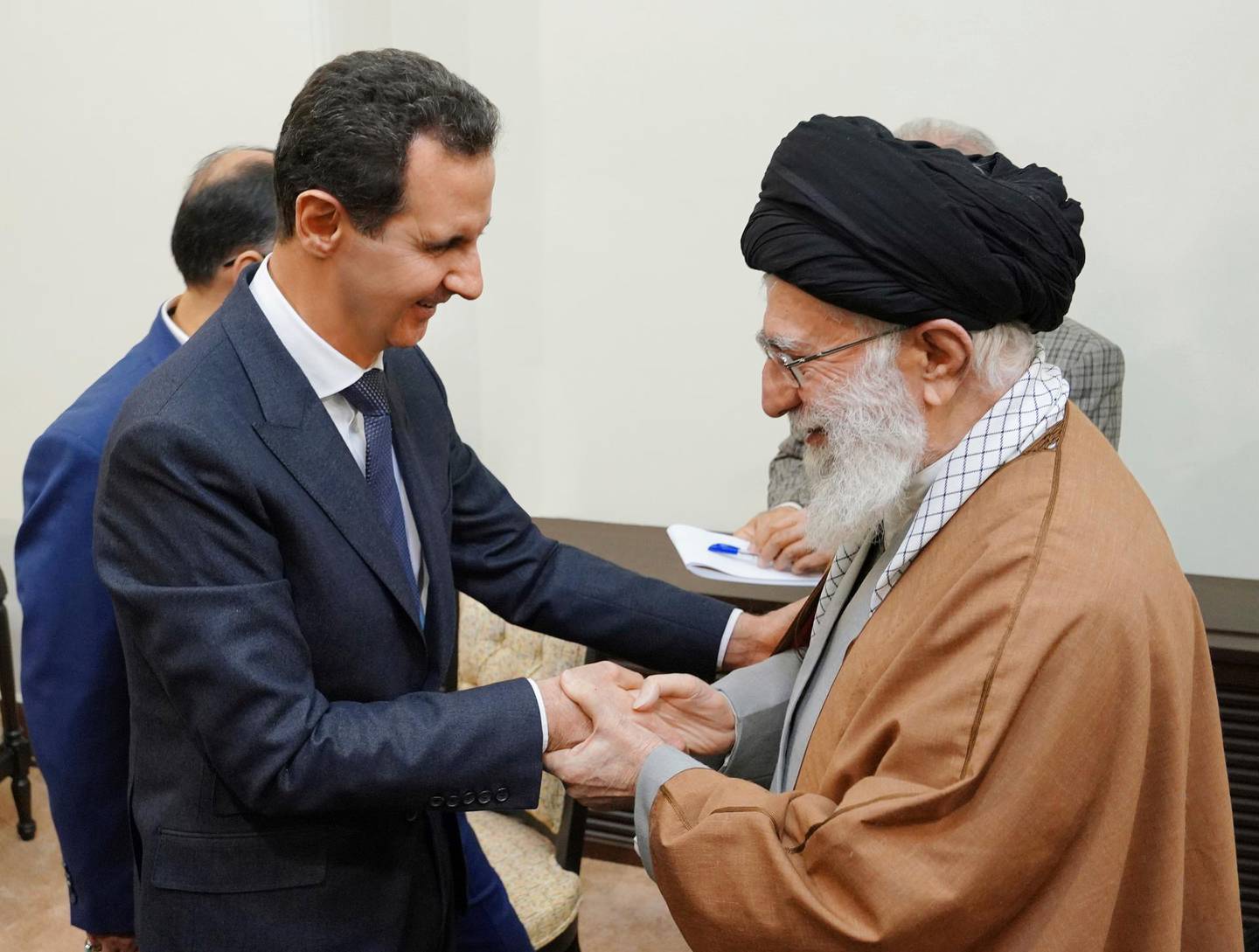 In this photo released by the Syrian official news agency SANA, Syrian President Bashar Assad, left, shakes hands with Iranian Supreme Leader Ayatollah Ali Khamenei, before their meeting in Tehran, Syria, Monday, Feb. 25, 2019. SANA said Assad met with Supreme Leader Ayatollah Ali Khamenei and President Hassan Rouhani on the trip, the first time he has traveled anywhere other than Russia since the Syrian civil war erupted nearly eight years ago. (SANA via AP)
