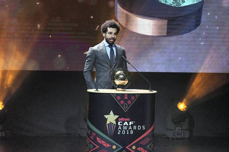 Liverpool's Egyptian forward Mohamed Salah speaks on stage with the 2018 African Footballer of the Year Award also called Ballon d'Or during the CAF award ceremony in dakar on January 8, 2019. (Photo by SEYLLOU / AFP)