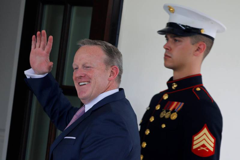 Outgoing White House Press Secretary Sean Spicer waves as he walks into the White House in Washington, U.S., July 21, 2017. REUTERS/Carlos Barria TPX IMAGES OF THE DAY