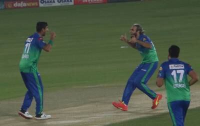 Multan Sultans' Shahnawaz Dhani, left, and Imran Tahir celebrate the wicket of Karachi Kings' Babar Azam. EPA