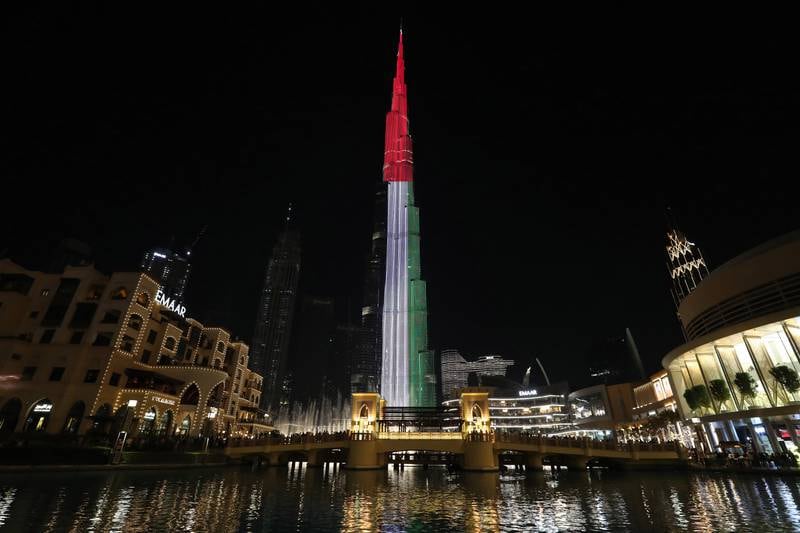The UAE flag displayed on Burj Khalifa. The IIF says higher oil prices will boost spending in the GCC. Pawan Singh / The National