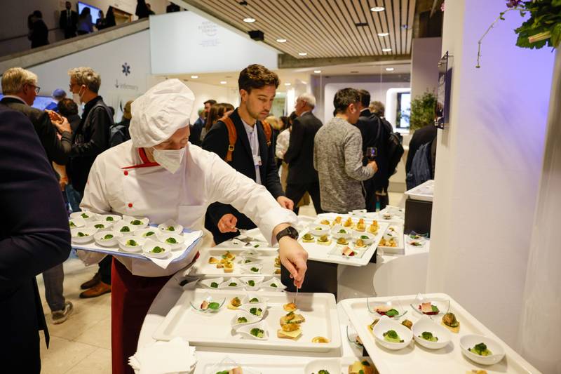 A chef serves canapes during the WEF's welcome reception in Davos. Bloomberg