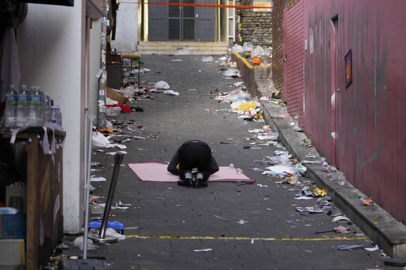 A man bows at the scene of Saturday's the crowd surge. AP