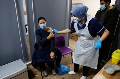 Abida Bi receives a  coronavirus disease (COVID-19) vaccine from nurse Zenub Mahood, at Bradford Central Mosque, amid the COVID-19 outbreak in Bradford, Britain, February 25, 2021. REUTERS/Jason Cairnduff