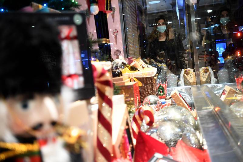 A shopper passes a Christmas window display in a store on Oxford Street in London. EPA