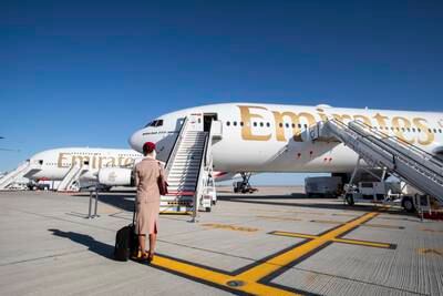 Emirates crew with an Emirates plane at the Dubai Airshow, Al Maktoum International Airport. Leslie Pableo for The National