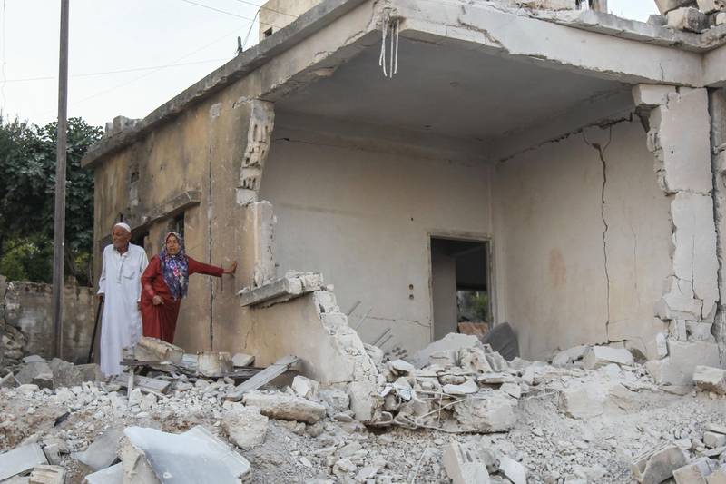 Syrians inspect the damage following reported regime airstrikes on the town of Muhambal, in the northern Idlib province on July 6, 2019. Syrian regime bombardment has killed 14 civilians including seven children in northwestern Syria, a war monitor said Saturday, in the latest deadly raids on the embattled opposition bastion
 / AFP / Amer ALHAMWE
