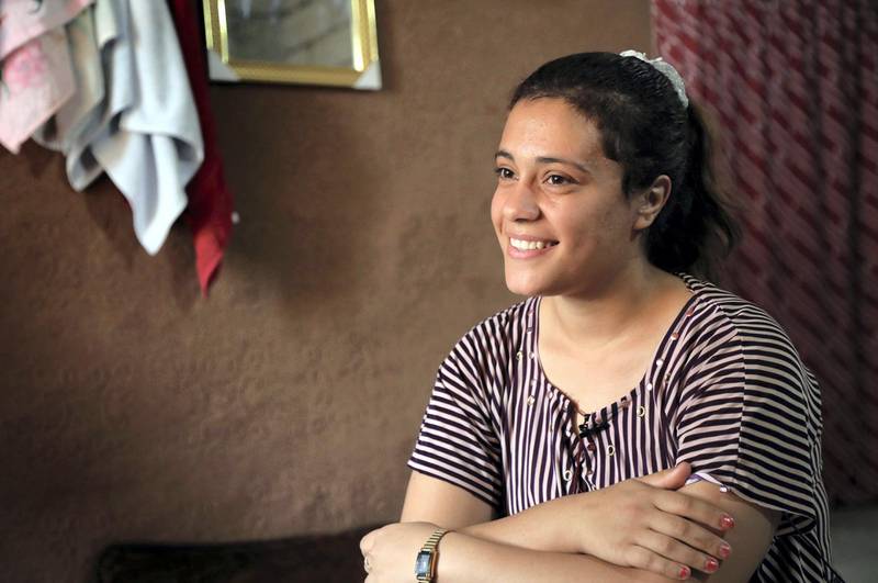 Iraq's Yazidi Jihan Qassem, 18, smiles as she talks to a AFP reporter at a makeshift house in an area housing many displaced people on the outskirts of the northwestern Iraqi town of Baadre on June 25, 2019. - Three children fathered by her Islamic State group husband. Three siblings missing since the Islamic State group ravaged her village in 2014. At 18, Yazidi survivor Jihan abandoned the former to honour the latter. The same gutwrenching dilemma has been faced by dozens of Yazidi women and girls forced to carry jihadists' children after IS abducted them from their ancestral Iraqi home of Sinjar in 2014. (Photo by SAFIN HAMED / AFP)