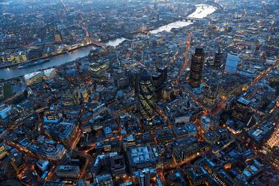 Aerial view of City of London over River Thames at night, London. (Photo by Cityscape Digital/Construction Photography/Avalon/Getty Images)