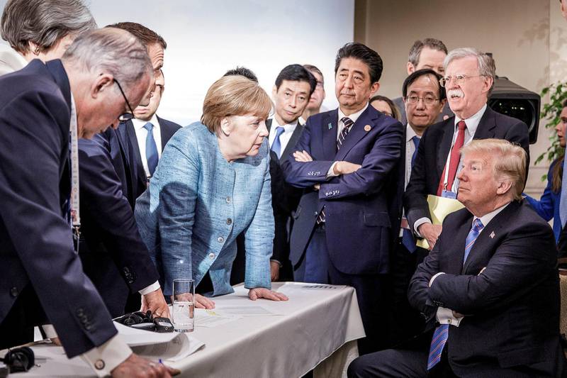 German Chancellor Angela Merkel speaks to US President Donald Trump during the G7 meeting in Charlevoix city of La Malbaie, Quebec, Canada, June 9, 2018. Reuters