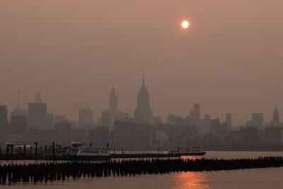 Buildings in the Manhattan skyine shrouded in smoke. Bloomberg