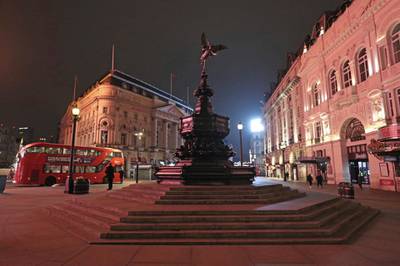 The statue of Eros stands in an empty Piccadilly Circus in London. AP Photo