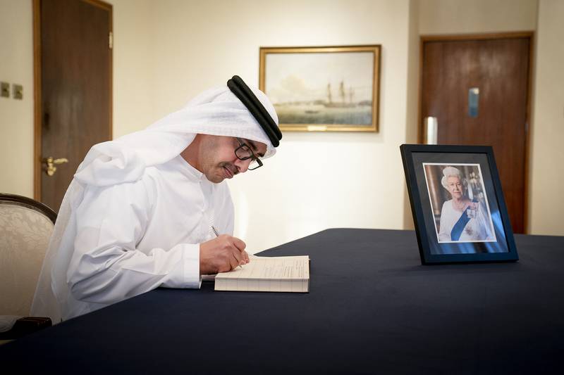 Sheikh Abdullah bin Zayed signs the book of condolence during a visit to the UK embassy in Abu Dhabi. Wam