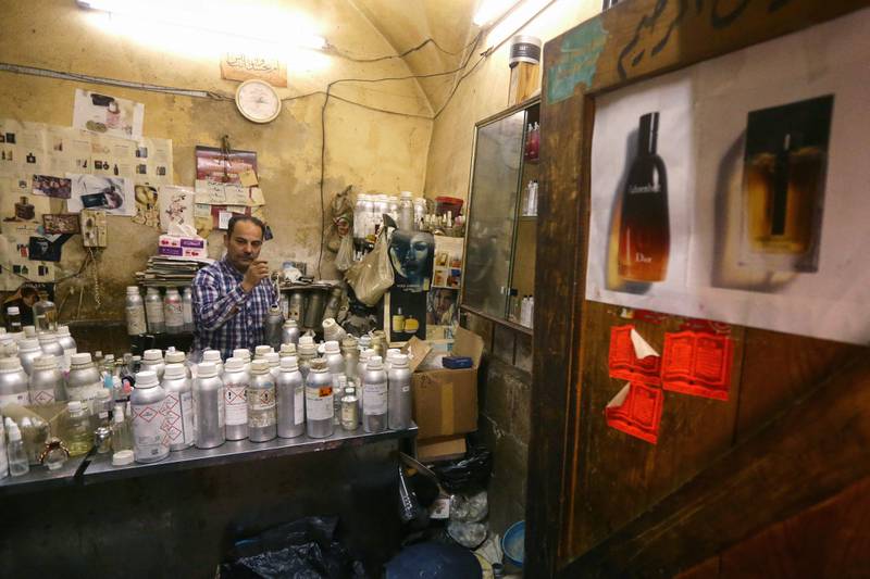 Al Masri lines up dozens of vials on a table - essences of jasmine, Damascus rose, musk and other fragrances used for his concoctions.