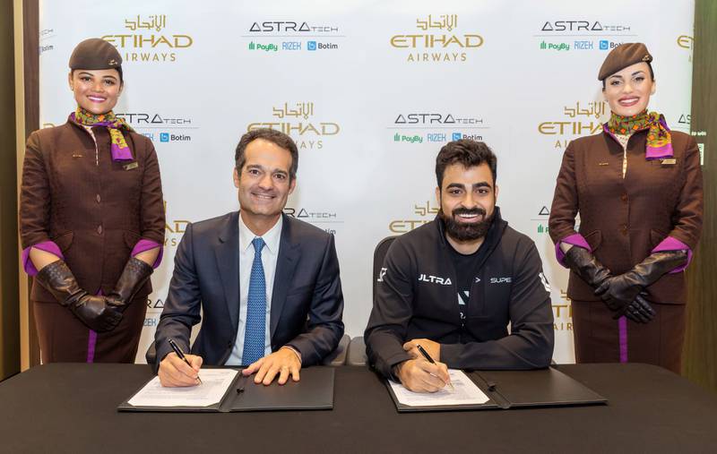 Antonoaldo Neves, chief executive of Etihad Airways, left, and Abdallah Abu Sheikh, founder of Astra Tech, during the signing ceremony at the Arabian Travel Market. Photo: Etihad