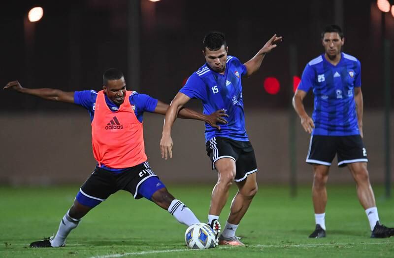 Defender Mahmoud Khamis tackles forward Fabio De Lima during training. Photo: UAE FA