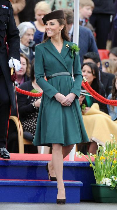 ALDERSHOT, ENGLAND - MARCH 17:  Catherine, Duchess of Cambridge presents shamrocks to members of the 1st Battalion Irish Guards at the St Patrick's Day Parade at Mons Barracks on Saturday March 17, 2012 in Aldershot, England.  450 soldiers were on parade, accompanied by the regimental mascot Conmeal, an Irish wolfhound who received his own sprig of shamrock from the Duchess. This was her first solo military engagement and she will now inherit a tradition which begun in 1901 by Queen Alexandra and more recently carried out for 32 years by the Queen Mother. Prince William is honorary Colonel of the Irish Guards. (Photo by Paul Vicente - WPA Pool/Getty Images)
